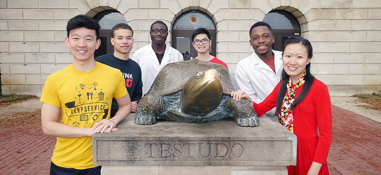 Students posing with Testudo outside McKeldin Library